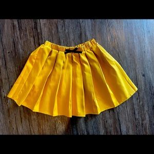 Gold pelted skirt with black bow
